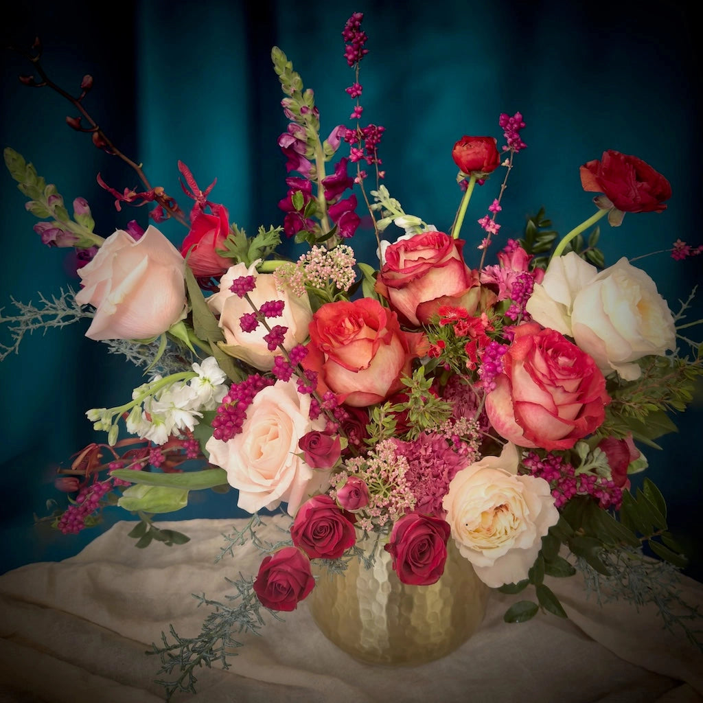 Candy Hearts is a lovely floral design for Valentine's Day in traditional shades of red, pink, and white. Designed in a gold vessel, each of our floral arrangements are designed using the best of seasonally available flowers. 
