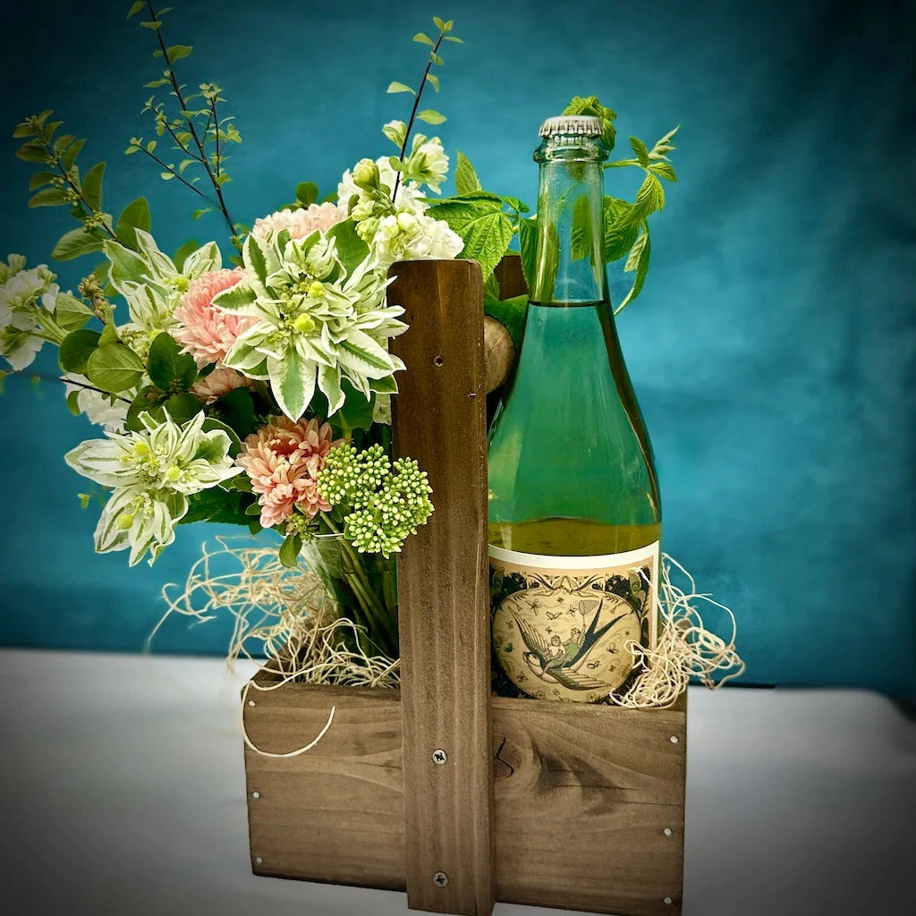 Campanula Design's handcrafted wooden wine caddy perfectly holds a designer's choice bud vase of flowers and a bottle of wine. Custom add-ons available.