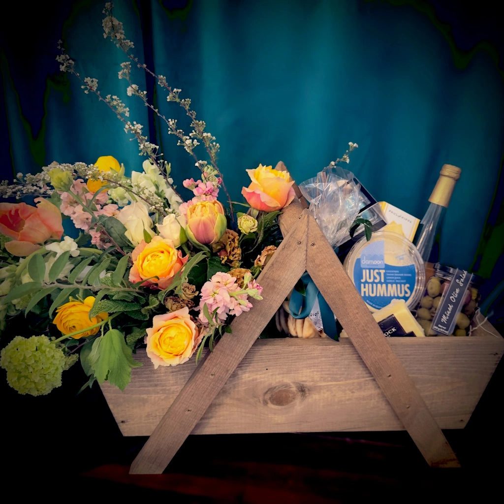 This gift basket from Campanula Design is perfect for those who want to customize their picnic basket and enjoy a picnic and flowers with the love of their life.