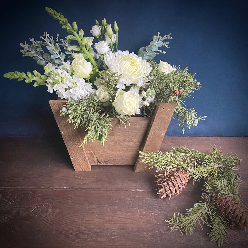 Winter floral arrangement from Campanula Design featuring white blooms and evergreens.