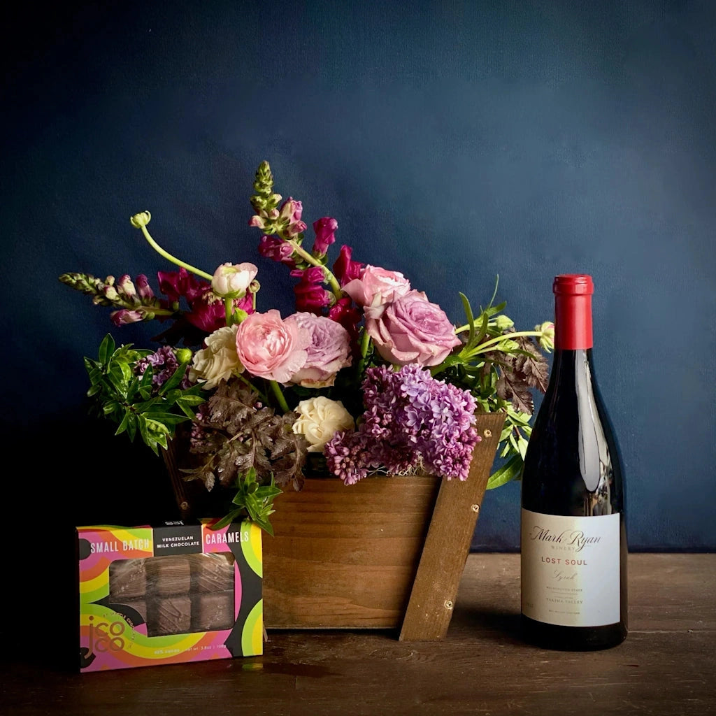 For delivery in the greater Seattle area, this gift basket features a bottle of Mark Ryan Winery wine and your choice of chocolate treat: a set of 6 Jcoco mini bars in assorted flavors - 3 milk and 3 dark, a set of two Mission chocolate bars (our choice of flavors), or a box of Wildwood Chocolate Texas Pecan Brittle.