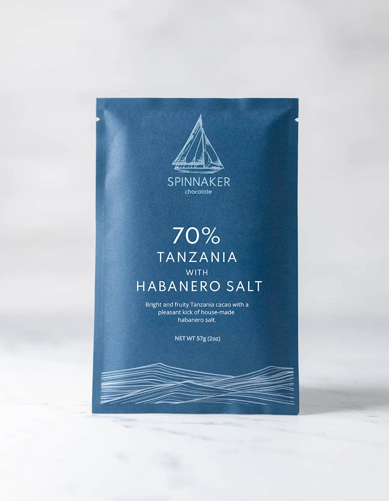Blue packaging of Spinnaker chocolate with Tanzania and Habanero Salt text on a white background.  Available from Campanula Design Studio, Seattle Florist and Luxury Gift basket company in the Magnolia Neighborhood.