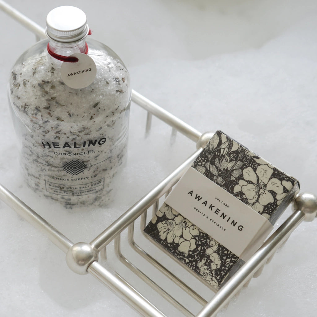 Bath Salt labeled 'Healing Chronicles' and a soap bar with 'Awakening' label on a metal tray.