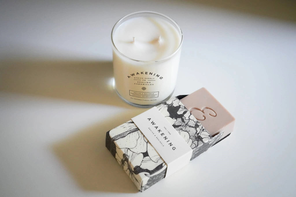 Candle and packaging labeled 'Awakening' on a light surface