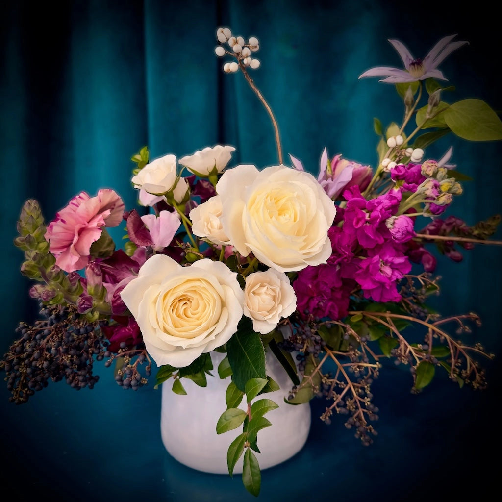 From Campanula Design Studio:"Berrylicious," a premium floral design with a palette of berry-toned blooms offset by creamy whites elegantly arranged in a neutral-toned vase. 