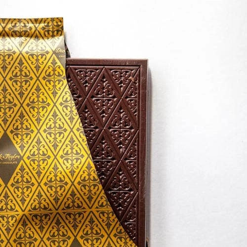 Patterned chocolate bar in a gold wrapper on a white background