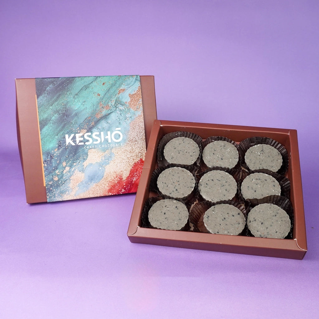 Box of KESSHO black sesame butter cups on a purple background.  Available for sale from Campanula Design Studio, Seattle florist and gift basket company in the Magnolia neighborhood.