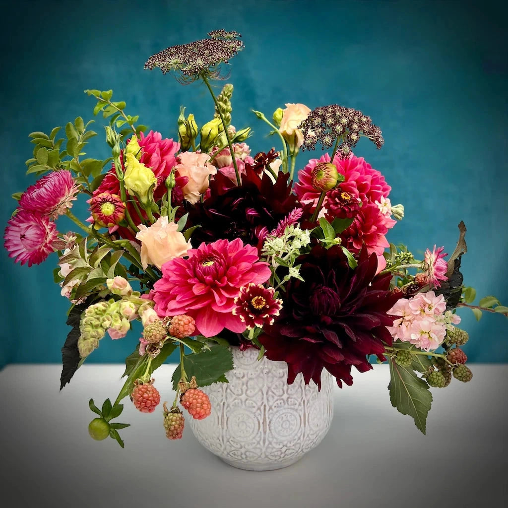 Campanula Design Studio's "Cabernet" flower arrangement features deep wine tones combined with lighter berry tones and pale pinks designed in a ceramic vase.