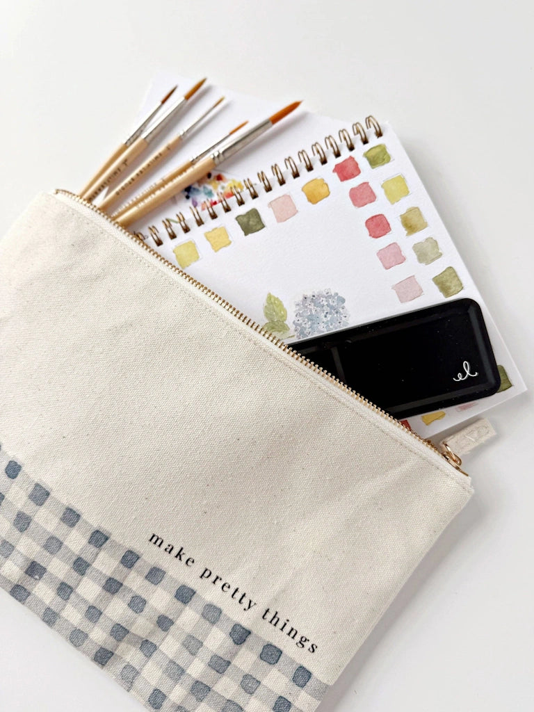Pencil case with checkered bottom, zipper, and stationery items on a white background.  Available for sale from Campanula Design Studio, Seattle florist and gift basket company in the Magnolia neighborhood.