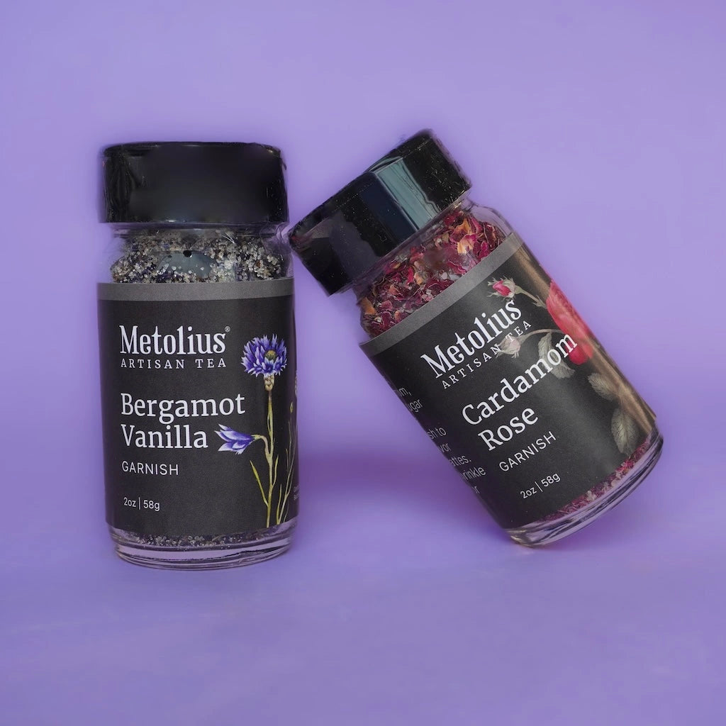 Two jars of Metolius Artisan Tea garnishes on a purple background