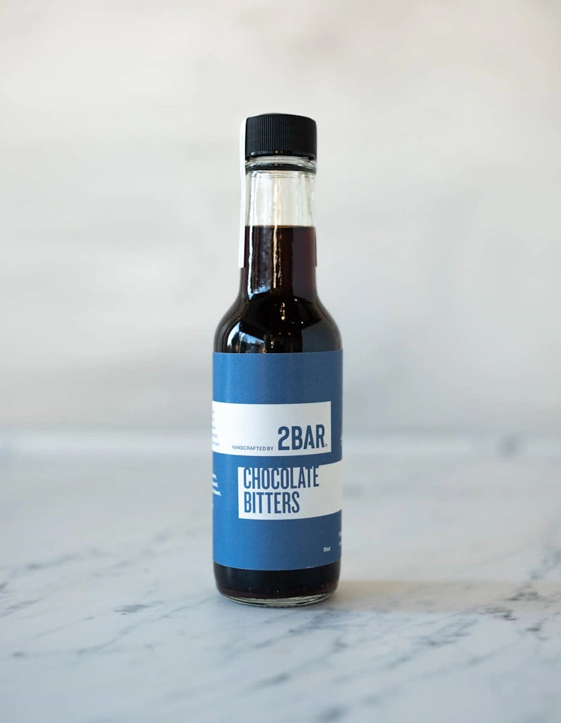 Bottle of Spinnaker 2BAR Chocolate Bitters on a marble surface.  Available for sale from Campanula Design Studio, Seattle florist and gift basket company in the Magnolia neighborhood.