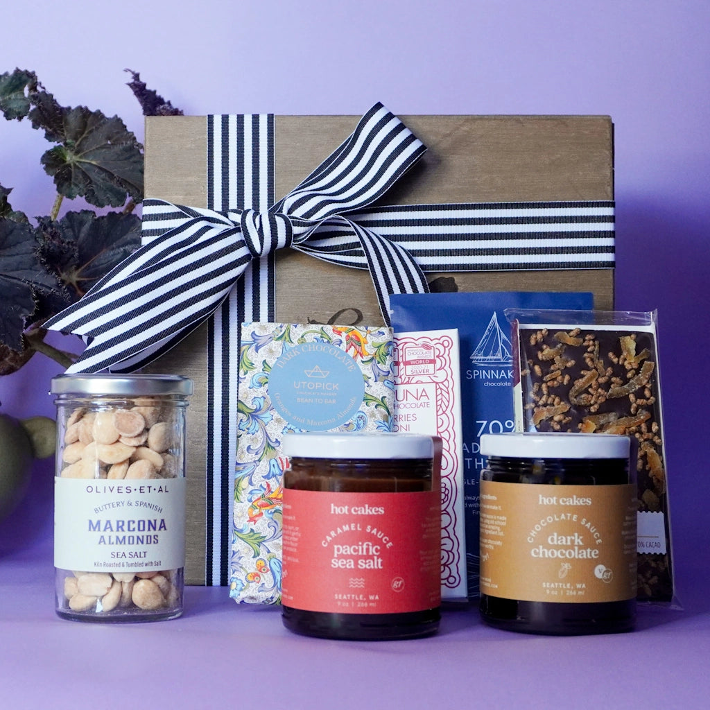 Shippable wooden gift box of artisanal chocolate bars, marcona almonds, chocolate syrup and caramel.