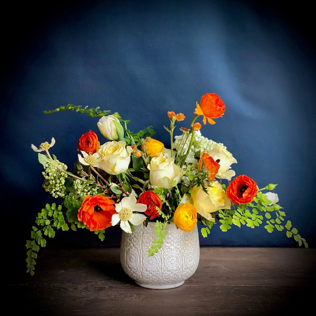 A custom floral of seasonal blooms in a saturated palette of buttery creams, bright oranges, and sunny yellows by Seattle florist Campanula Design Studio. Same and next day flower delivery available