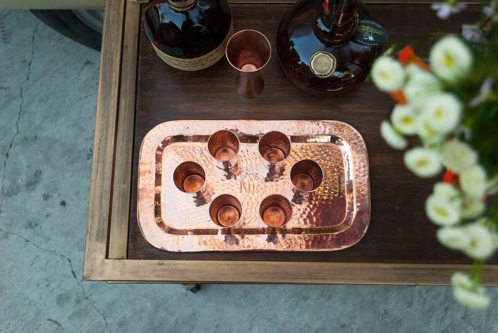 Copper bareware from Campanula Design Studio. The Charolita copper tray adds a special touch to your favorite flight of spirits or bar set up