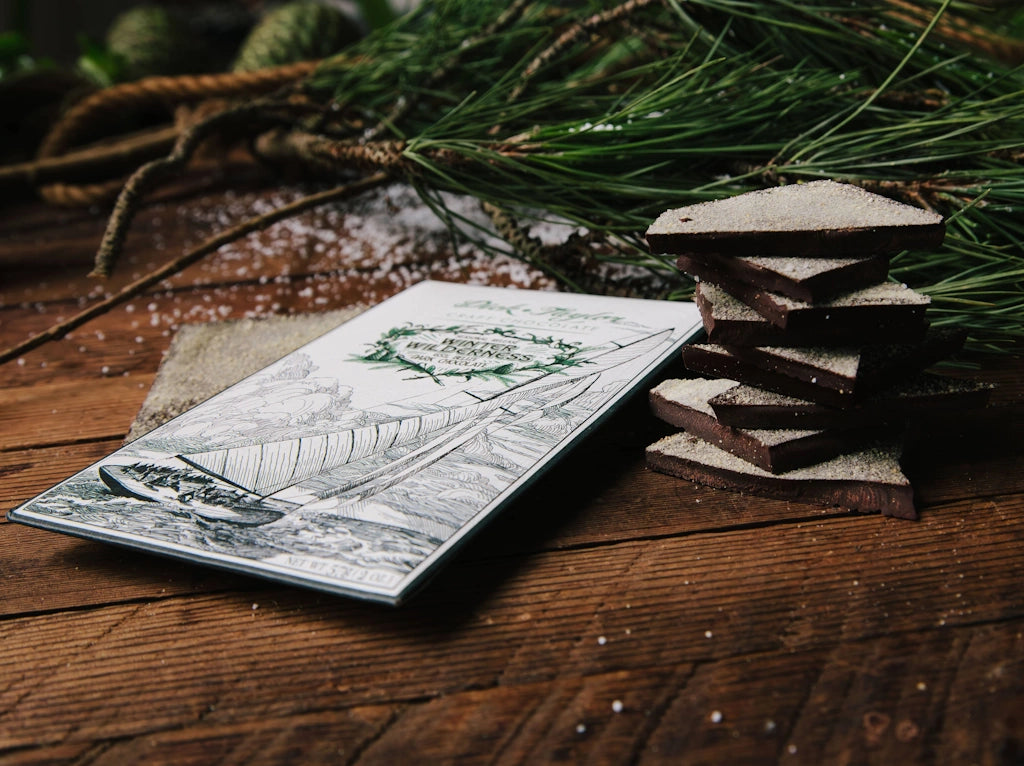 Stack of chocolate bars with a decorative card on a wooden surface