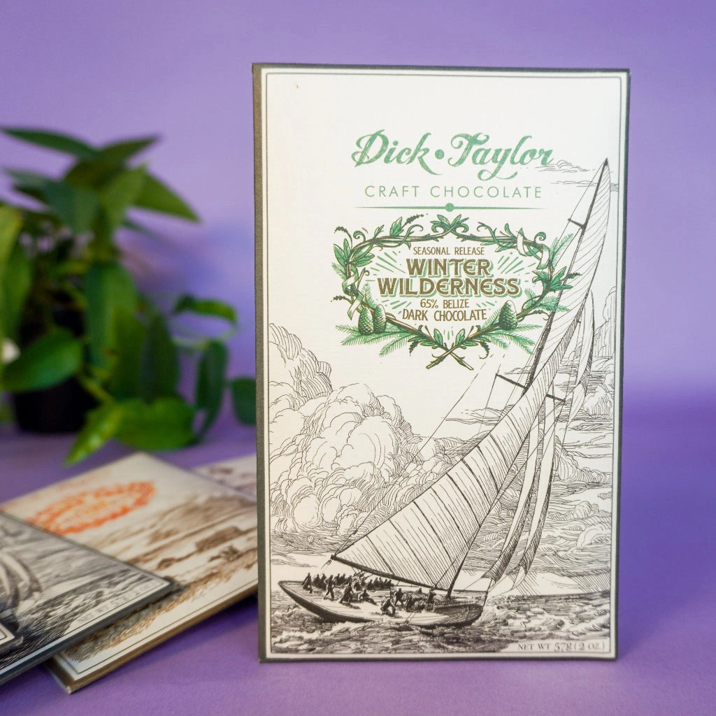 Dick Taylor WInter Wilderness craft chocolate packaging with sailboat illustration on a purple background