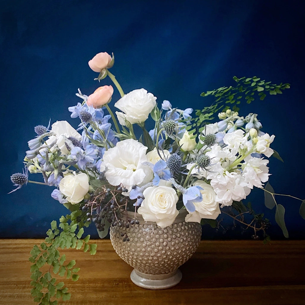 "Dream a Little Dream" is a dreamy floral arrangement - it features a alette of blues, whites, and just a subtle pop of soft peach designed in a ceramic vessel. Available in our shop in Magnolia in Seattle or for delivery in the Greater Seattle area.