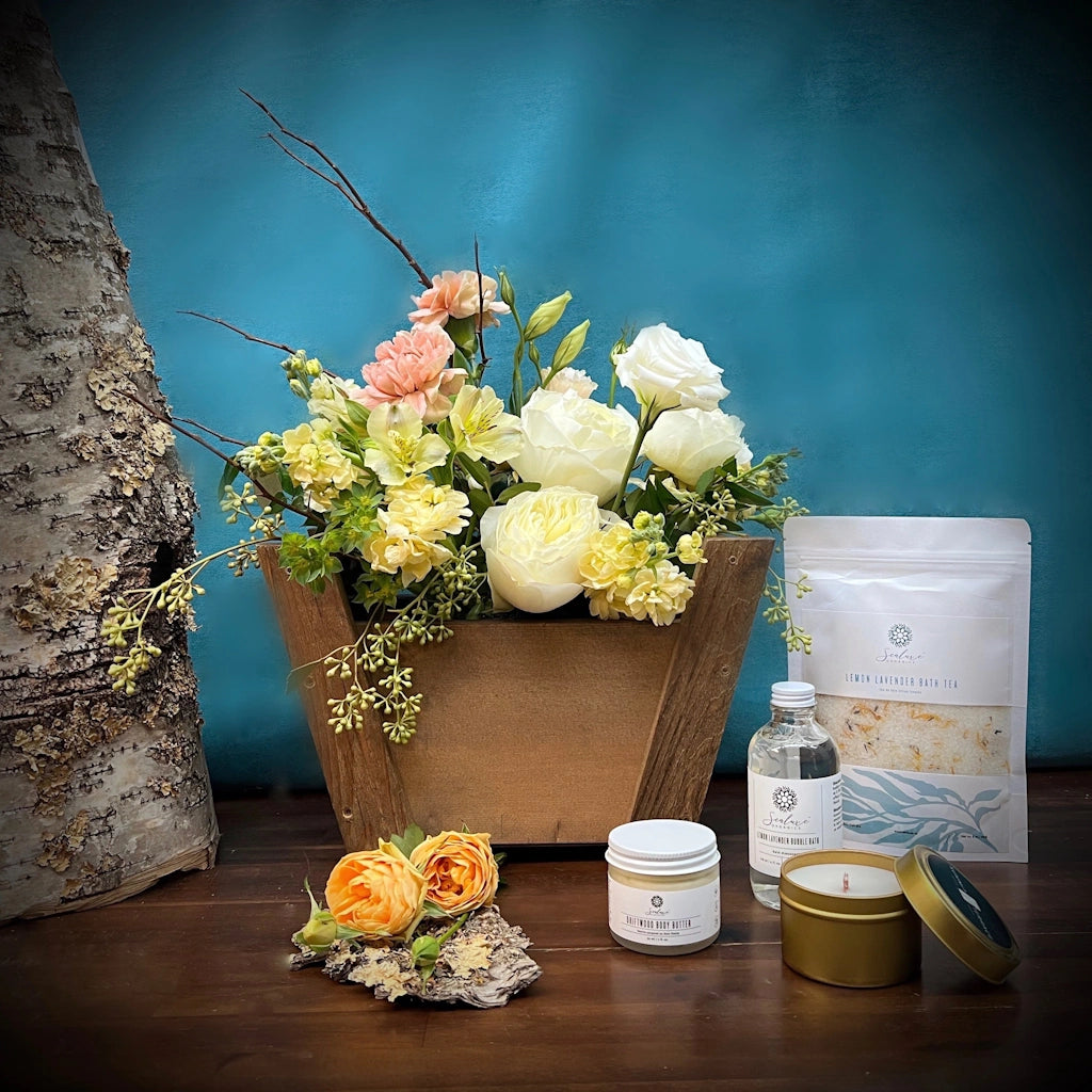 Flowers, Sealuxe spa products, and Summit & Terrace candle all designed in the signature Petit Panier basket by Seattle florist Campanula Design Studio.