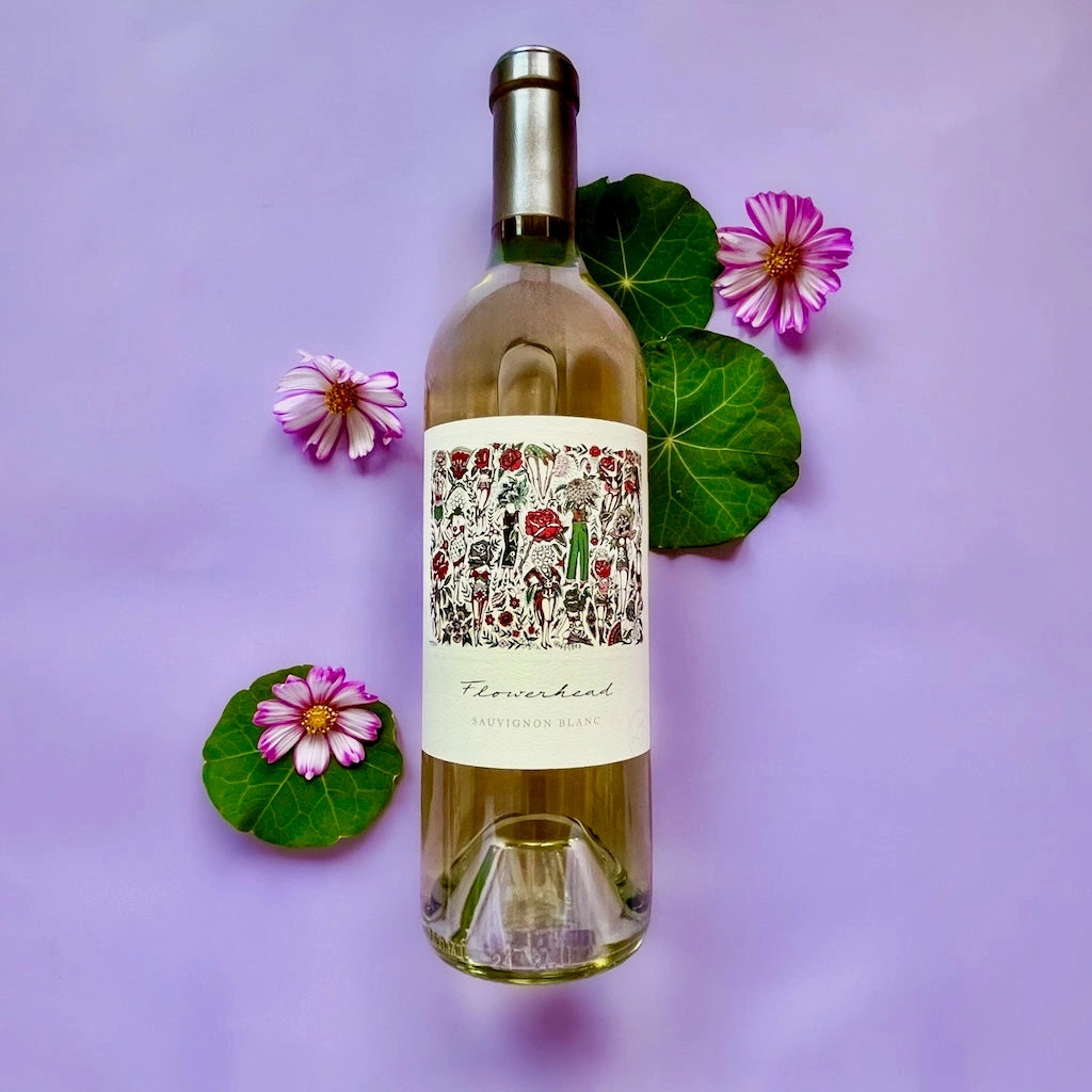 Mark Ryan Flowerhead Sauvignon Blank Wine bottle with decorative label surrounded by flowers and leaves on a purple background