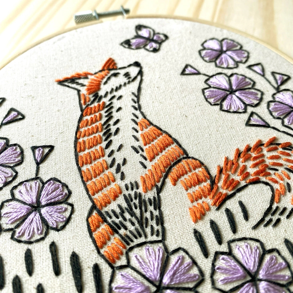Embroidery hoop with a fox and floral design.