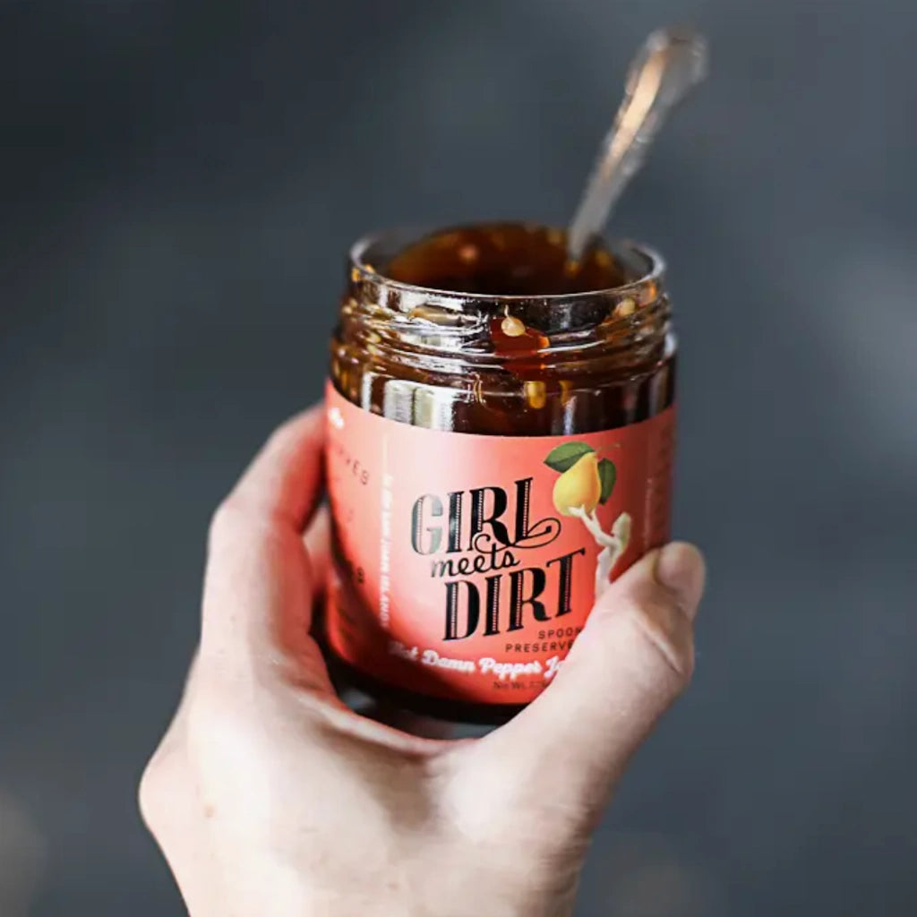 From Campanula Design Studio: Girl Meets Dirt Hot Damn Pepper Jam Spoon Preserves. This Good Food Awards 2021 Finalist is not your usual pepper jelly. This is one of those jars you need in your refrigerator to spice up lackluster meals (visualize dipping coconut shrimp or topping grilled salmon) and serve as an instant cheese pairing by slathering on cream cheese and crackers at a moment’s notice.