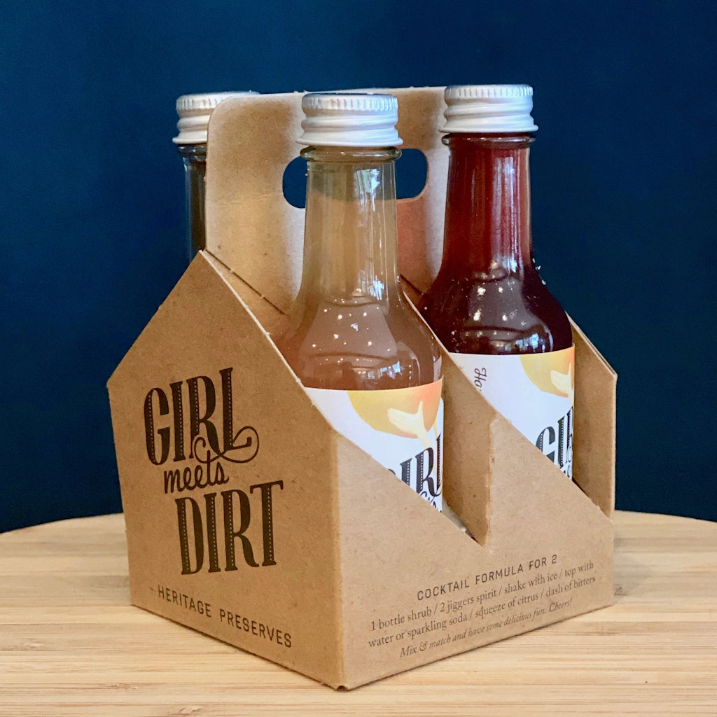Girl Meets Dirt sweet and sour shrubs. Mix with spirits for a cocktail or with soda water for a delicious mocktail, Flavors include: Ruby Spiced Apple, and Island Pear in 2 ounce bottles. 