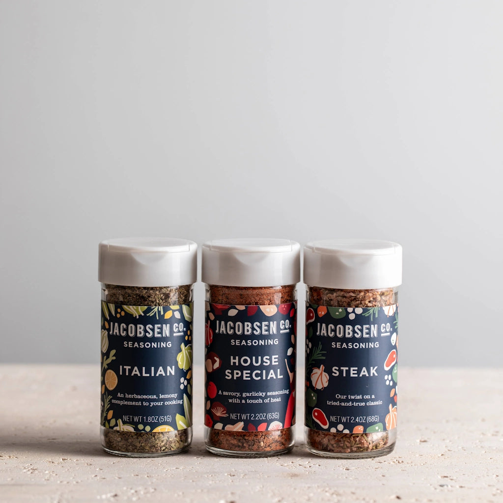 Three jars of Jacobsen Salt Co. seasoning on a light surface with a neutral background
