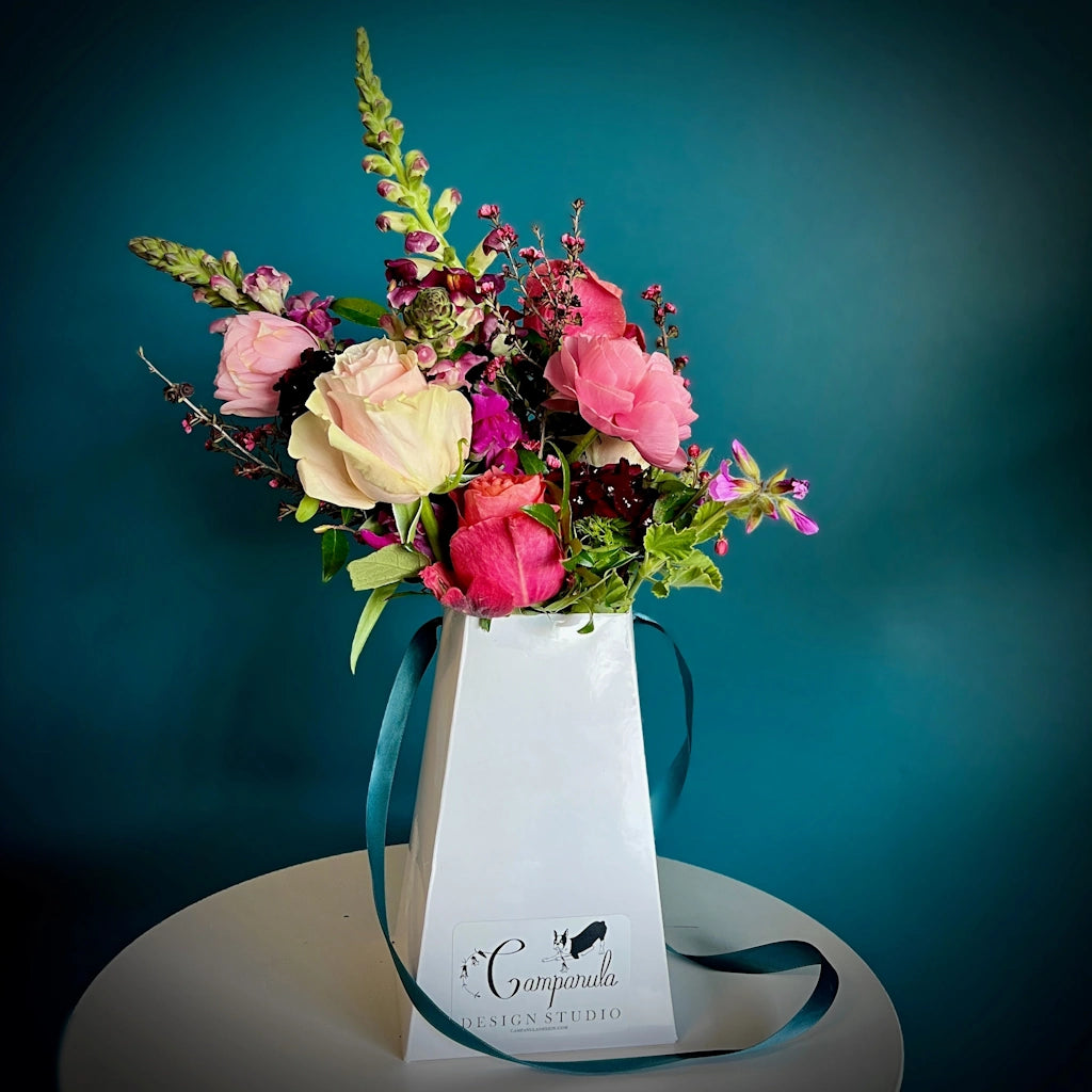 Hand tied bouquet in a reusable flower box from Campanula Design Studio.