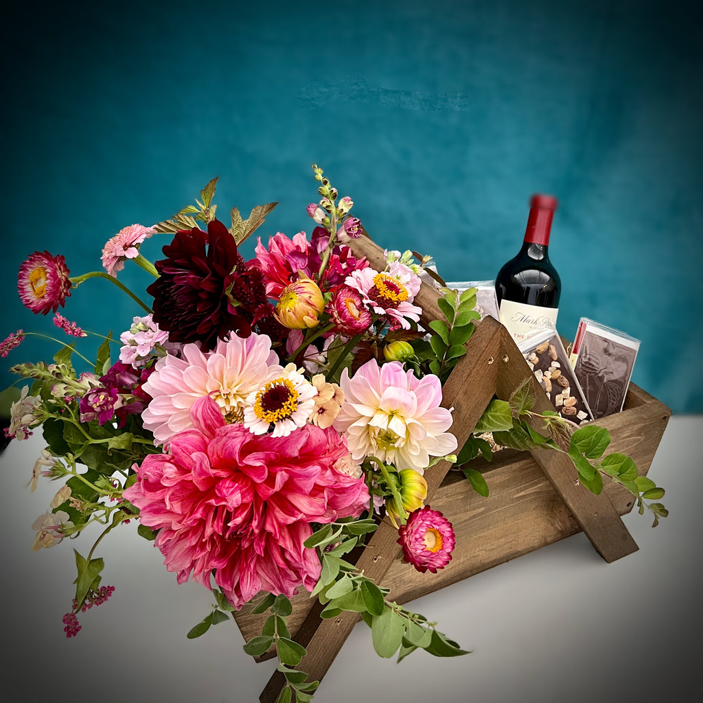 A custom gift basket of flowers, wine, and other goods by Seattle gift basket company Campanula Design. Handmade. Available for local delivery.