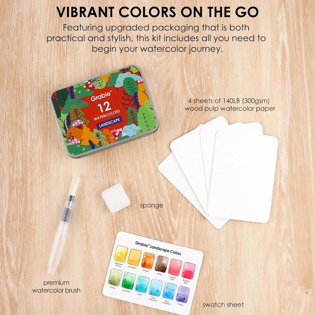 Grabie watercolor kit with paper, brush, and swatch sheet on a wooden surface