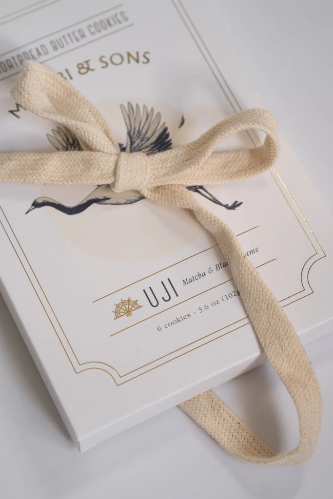 Box of UJI Matcha shortbread cookies with a beige ribbon on a white background. Available from Campanula Design Studio, Seattle florist and gift basket company in Magnolia.