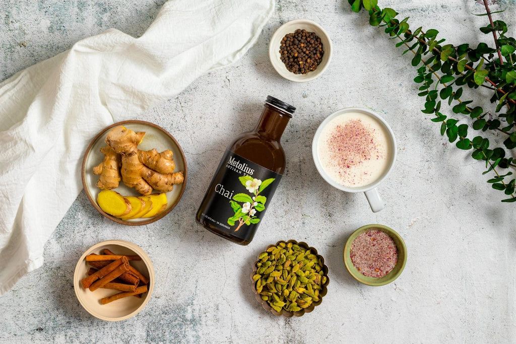Bottle of Metolius chai pictured with some of the spices making up this unique brand of chai.