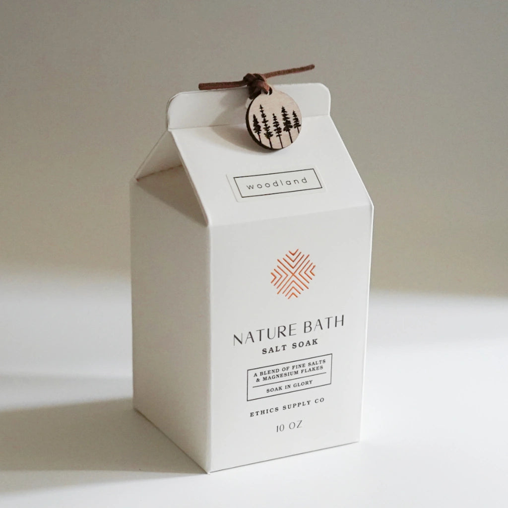 Nature Bath Salt Soap packaging with a wooden tag on a neutral background