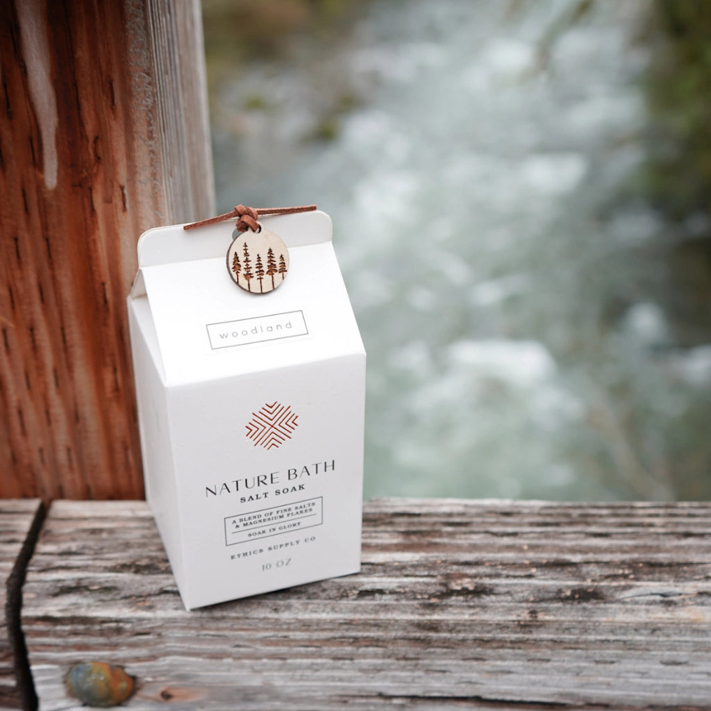 Nature Bath Salt Soak packaging on a wooden surface with a blurred natural background
