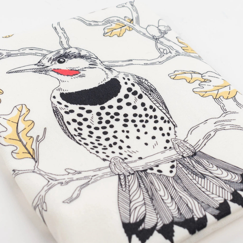 This tea towel showcases an intricately detailed Northern Flicker in a deciduous Oak tree setting. 
This tea towel makes a great upgrade to go with your Seattle flower delivery, gift basket, houseplant or other gifting option.