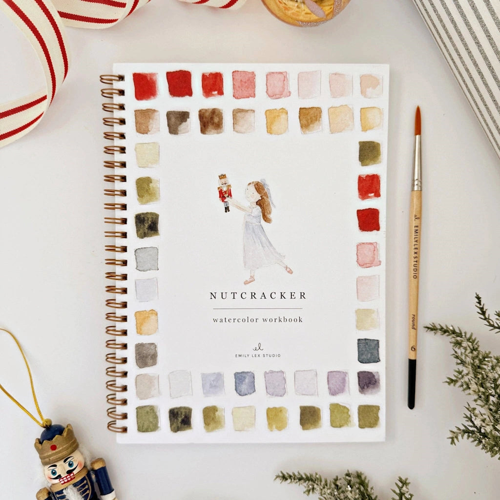 Watercolor workbook titled 'Nutcracker' with color swatches on a white surface.