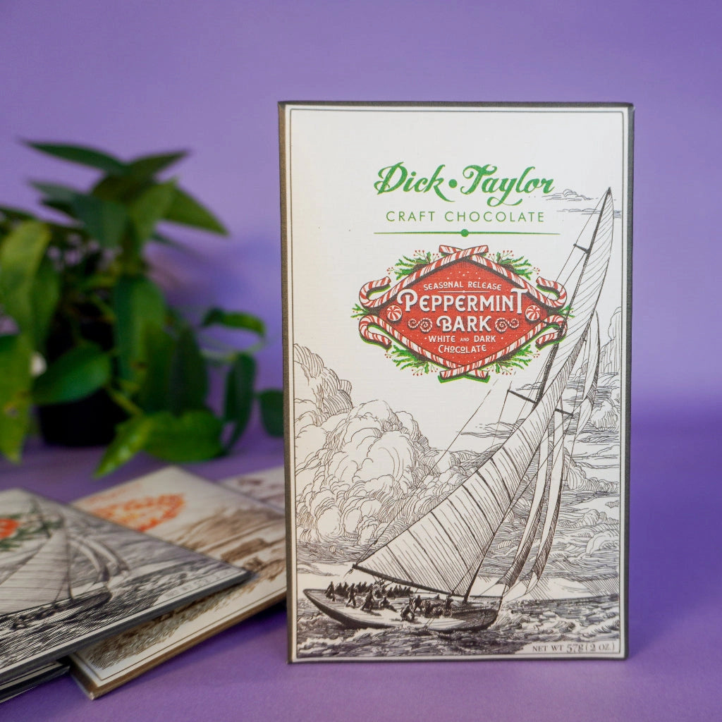 Dick Taylor craft chocolate packaging with sailboat illustration on a purple background