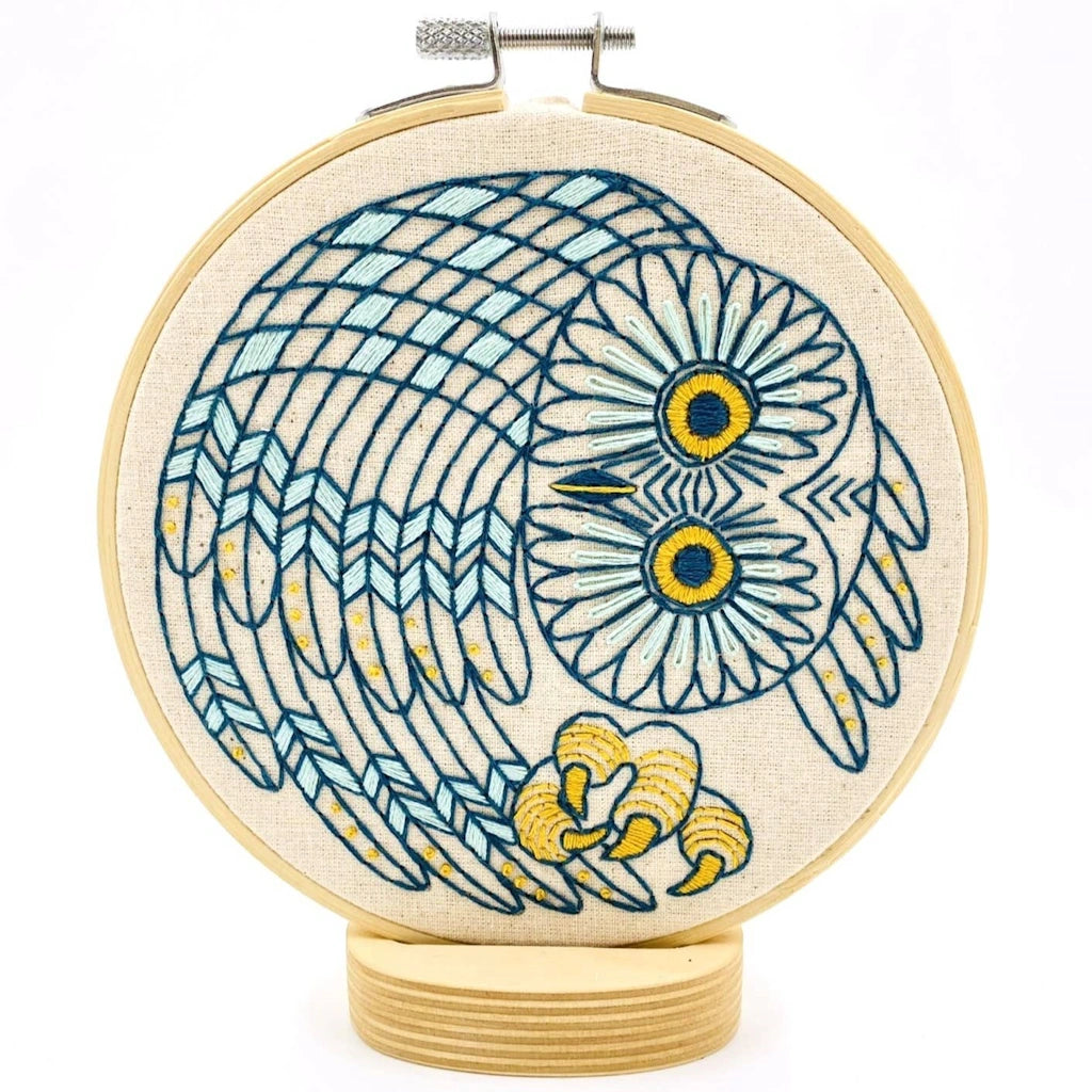 Embroidery hoop with owl design on a white background