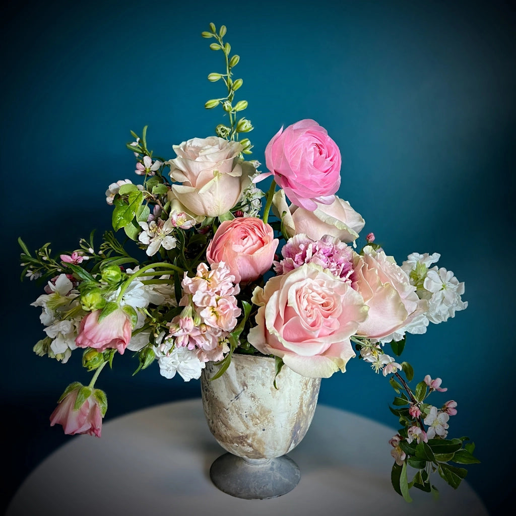 A seasonal floral design of soft pinks, bright whites, and pops of hot pink. Perfect for Valentine's Day flowers.