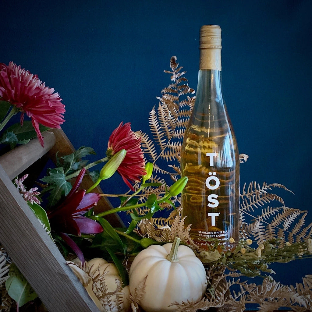 TÖST is a pure and delicious dry sparkling beverage of white tea, white cranberry, and ginger. Equally satisfying as a daily refreshment as it is paired with fine dining, A perfect addition to one of Campanula Design Studio's gift baskets or floral designs.
