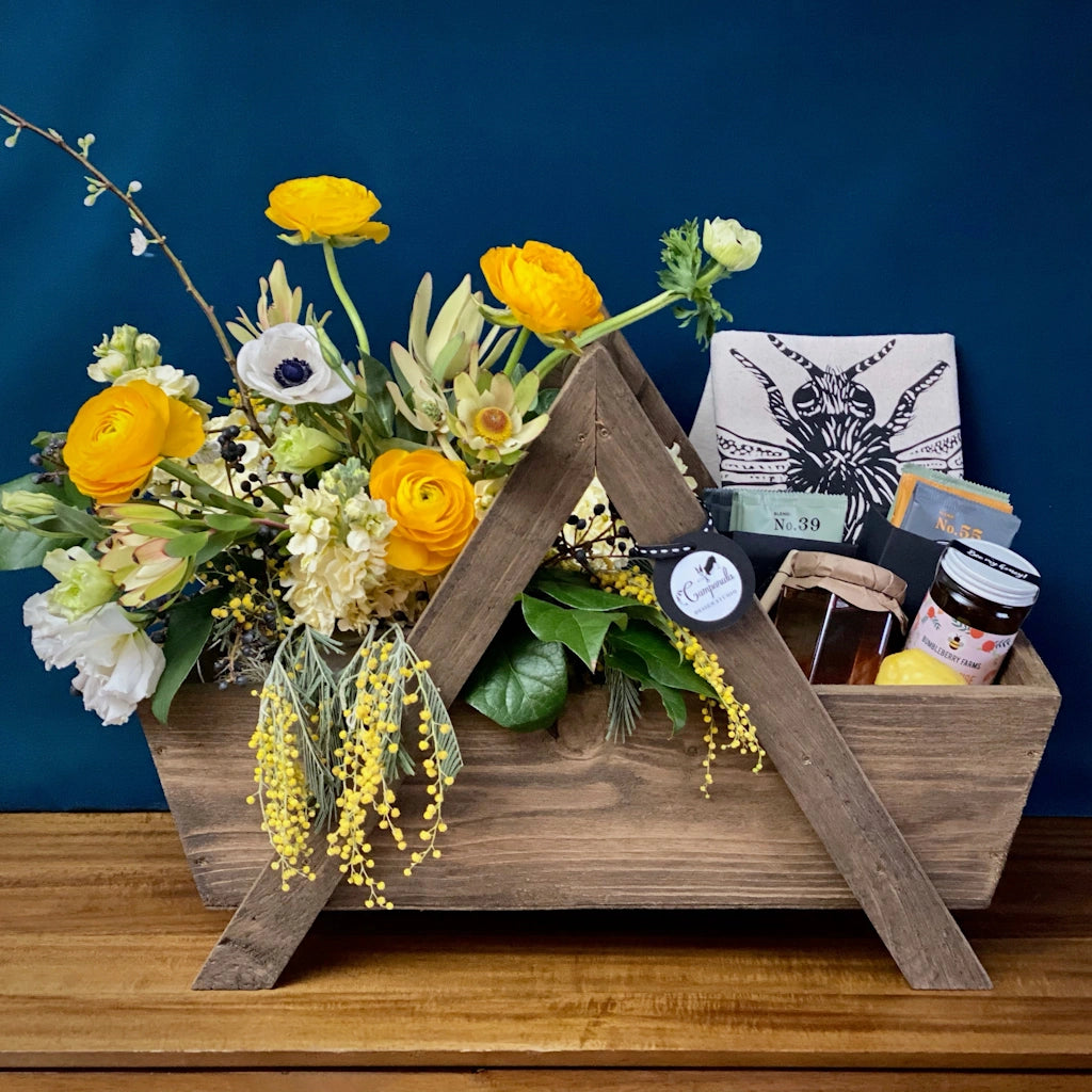 Tea & Honey: A custom handmade wooden gift basket featuring a seasonally inspired floral, Smith Teamaker teas, Jacobsen Salt Co honey, and a sweet tea towel. Designed by Seattle florist Campanula Design Studio.