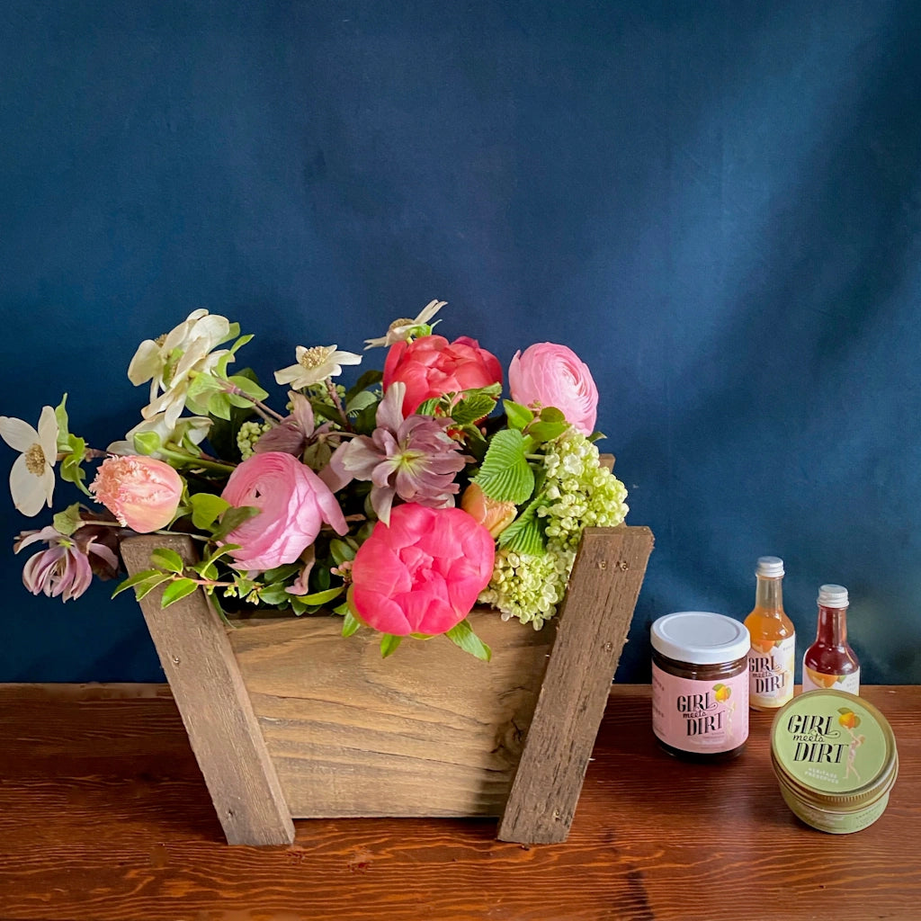 Inspired by the bounty of our orchards, this petite basket is a celebration of the state of Washington. Out on Orcas Island, Girl Meets Dirt is hand making beautiful award winning heritage fruit preserves in copper pots. A selection of products including one spoon preserve, one cutting preserve, and two mini shrubs complete this basket.