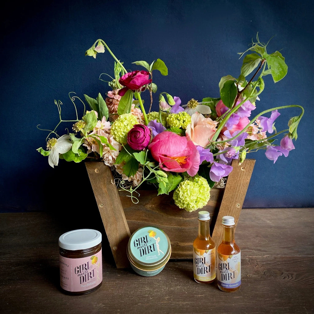 Inspired by the bounty of our orchards, this petite basket is a celebration of the state of Washington. Out on Orcas Island, Girl Meets Dirt is hand making beautiful award winning heritage fruit preserves in copper pots. A selection of products including one spoon preserve, one cutting preserve, and two mini shrubs complete this basket.