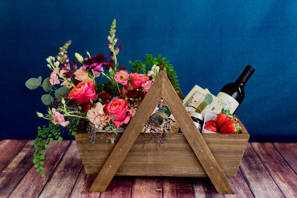 Campanula Design's "To Make You Feel My Love" gift basket makes for the perfect date night.  A floral in luxurious shades of burgundies, reds, and pinks is designed within our signature wooden basket. A bottle of wine (or sparkling beverage) to share, some strawberries and chocolate sauce, and two cards to write personalized love notes to one another set the tone for a perfectly romantic evening.