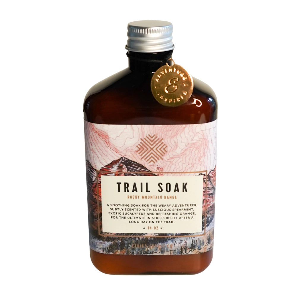 Bottle of 'Trail Soak' with a decorative label on a white background