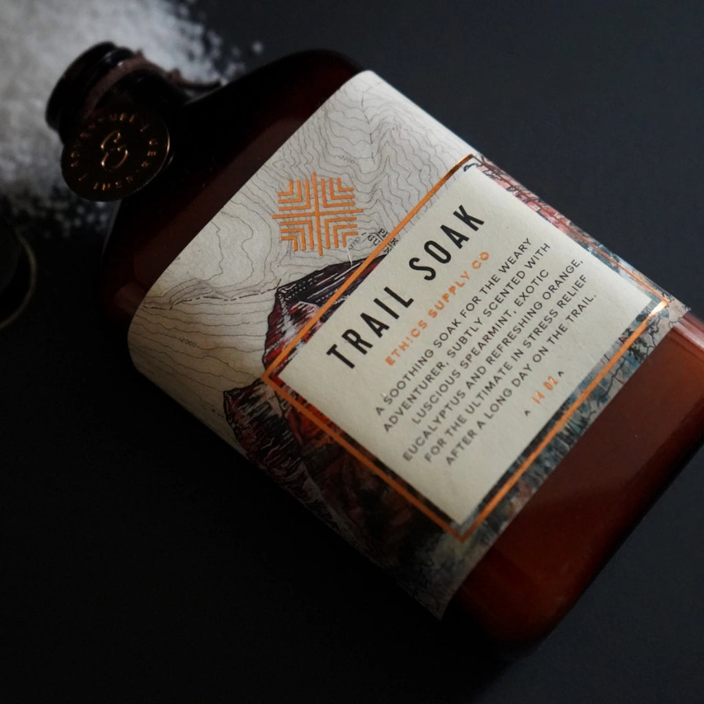 Bottle of Trail Soak with a label on a dark background