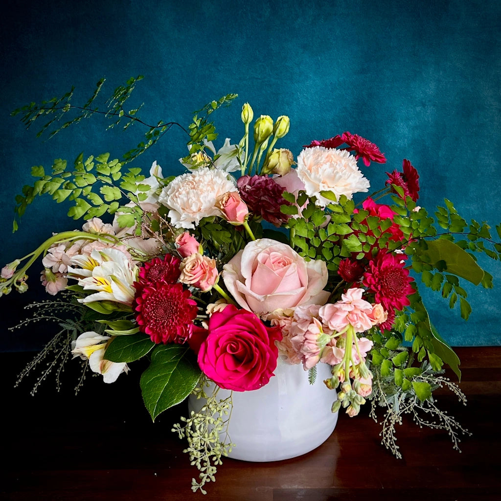A custom floral of seasonal blooms in a saturated palette of corals, raspberries, and pale pinks by Seattle florist Campanula Design Studio. Same and next day flower delivery available.