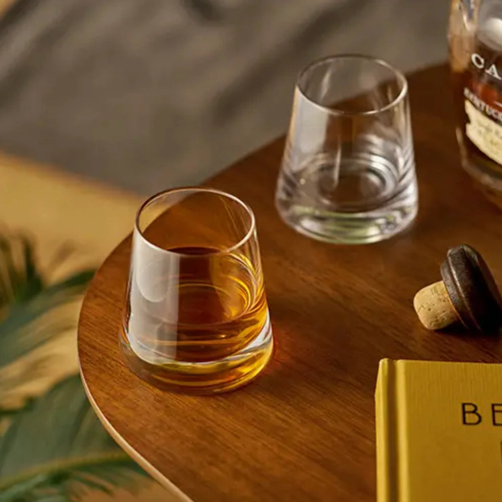 Burke whiskey glasses have a unique tapered form that creates a striking pyramid. Perfect for sipping Scotch neat or enjoying an Old Fashioned, each tumbler has a heavy base and a quiet elegance that brings modern flair to any home bar or occasion.